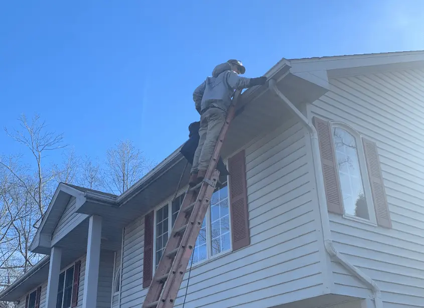 Gutter cleaning and maintenance being performed by Lakewood Power Washing in Lakewood